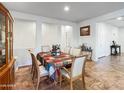 Bright dining room with tile floors, natural light, and a table set for six at 17542 W Pinnacle Vista Dr, Surprise, AZ 85387