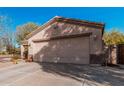 Single-story home with a two-car garage and desert landscaping at 17634 W Hearn Rd, Surprise, AZ 85388