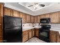 Classic kitchen featuring oak cabinets, modern black appliances, and neutral countertops at 1825 W Ray Rd # 2116, Chandler, AZ 85224