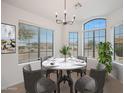 Bright dining area with large windows offering natural light and views of the outdoors at 2416 E Cielo Grande Ave, Phoenix, AZ 85024