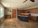 Open kitchen featuring stainless steel appliances, center island, and tile flooring at 2539 E Hazeltine Way, Chandler, AZ 85249