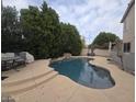 Backyard pool featuring rock accents, a stone border, and patio umbrella at 2539 E Hazeltine Way, Chandler, AZ 85249