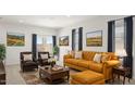 Cozy living room with an orange sofa set and patterned rug at 25401 W Sunland Ave, Buckeye, AZ 85326