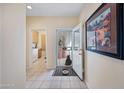 Inviting foyer with tiled floor leading to an open-concept living space and a glimpse of the laundry room at 2568 N Armour Ave, Mesa, AZ 85215