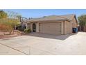 Exterior shot featuring a two-car garage, neutral stucco and a well-maintained front yard at 3023 E John Cabot Dr, Phoenix, AZ 85032