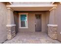 Inviting front porch with stone accents and a covered entryway at 3025 W Night Owl Ln, Phoenix, AZ 85085