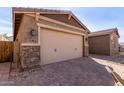 Spacious two-car garage with brick driveway and desert landscaping at 3025 W Night Owl Ln, Phoenix, AZ 85085