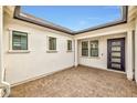 Cozy private outdoor patio with paved flooring and a view of the home's exterior windows and door at 34315 N Sandpiper Trl, Queen Creek, AZ 85144