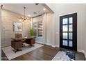 Stylish office space with a decorative front door, desk, and a faux-stone accent wall at 34801 N 53Rd St # 2, Cave Creek, AZ 85331