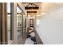 Bright hallway with shiplap walls, dark wood floors, and a view of the backyard at 34801 N 53Rd St # 2, Cave Creek, AZ 85331