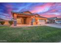 Beautiful single-story home boasts a covered porch, lush lawn, and inviting curb appeal at 3768 S Coach House Dr, Gilbert, AZ 85297