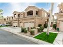 A two-story home featuring a multi-car garage, a second story balcony and desert landscaping at 3800 S Cantabria Cir # 1013, Chandler, AZ 85248