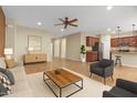 Expansive living room with an open floor plan, neutral color palette, and view into the kitchen area at 42906 W Darter Dr, Maricopa, AZ 85138