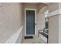 A welcoming front door with 'hello' doormat and seating area by the entryway at 4473 E Whitehall Dr, San Tan Valley, AZ 85140