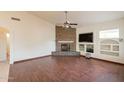 Spacious living room featuring a stone fireplace, wood floors, and built-in shelving at 4552 E Chuckwalla Cyn, Phoenix, AZ 85044