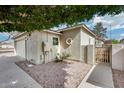 Charming home exterior featuring desert landscaping, side yard access, and neutral stucco in a quiet neighborhood at 4725 E Brown Rd # 59, Mesa, AZ 85205