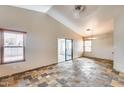 Bright living room featuring tile floors, high ceilings, and sliding glass doors leading to the outdoor space at 4725 E Brown Rd # 59, Mesa, AZ 85205