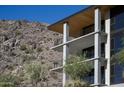 Close up of a modern building with balconies and desert landscaping at the base of a mountain at 5000 N Camelback Ridge Rd # 210, Scottsdale, AZ 85251