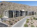 Beautiful modern condo building with balconies and desert landscaping at the base of a mountain at 5000 N Camelback Ridge Rd # 210, Scottsdale, AZ 85251