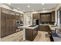 Spacious kitchen with stainless steel appliances, an island cooktop, and ample cabinet storage at 5210 E Danbury Rd, Scottsdale, AZ 85254