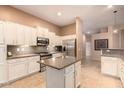 Modern kitchen with granite countertops, stainless steel appliances, and white cabinetry at 6159 W Sequoia Dr, Glendale, AZ 85308