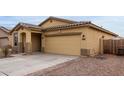 Inviting home featuring a two-car garage, desert landscaping, and a charming covered entryway at 7221 W Wood St, Phoenix, AZ 85043