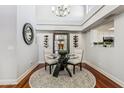 Elegant dining area with a glass table, stylish rug, and modern chandelier lighting at 7800 E Lincoln Dr # 1007, Scottsdale, AZ 85250