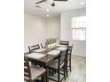 Dining room with a dark wood table and seating for six, accented by a floral centerpiece at 8907 W Bethany Heights Dr, Glendale, AZ 85305