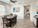 Bright dining room with a ceiling fan, tile floors, and views of the entryway and hallway at 8907 W Bethany Heights Dr, Glendale, AZ 85305