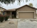 Charming single-Gathering home featuring a two-car garage and landscaped front yard at 9017 W Kirby Ave, Tolleson, AZ 85353