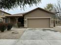 Charming single-Gathering home featuring a two-car garage and landscaped front yard at 9017 W Kirby Ave, Tolleson, AZ 85353