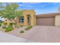 Lovely single-story home with a well-manicured yard and a brick driveway at 908 E Cereus Pass, Queen Creek, AZ 85140