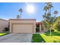 Charming single-story home featuring a two-car garage, well-manicured lawn, and towering palm trees in sunny Arizona at 9329 W Topeka Dr, Peoria, AZ 85382