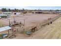 Large horse arena with sturdy fencing, equipped with stalls, providing ample space for equestrian activities at 97 W Marilyn Way, San Tan Valley, AZ 85140