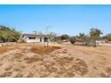 A large dirt backyard showcasing the property and the 11512 address sign at 11512 E 6Th Ave, Apache Junction, AZ 85120