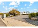 Wide, circular driveway leading to a modern home with desert landscaping and a blue sky at 12201 N 66Th St, Scottsdale, AZ 85254