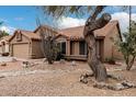 Single-story home featuring desert landscaping, a two-car garage, and a terracotta tiled roof at 14404 N 56Th Pl, Scottsdale, AZ 85254