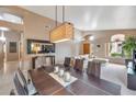 Dining room with modern chandelier and view into the living area at 14447 N 100Th Way, Scottsdale, AZ 85260