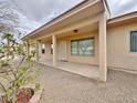 Covered patio area with stylish columns and desert landscaping at 14545 S Cherry Hills Dr, Arizona City, AZ 85123