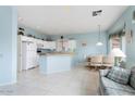 Bright kitchen with white appliances, tile flooring, breakfast nook, and ample counter space at 15924 W Falcon Ridge Dr, Sun City West, AZ 85375