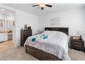 Comfortable main bedroom with a ceiling fan, neutral decor, and an ensuite bathroom at 17055 W El Caminito Dr, Waddell, AZ 85355