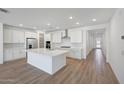 Spacious kitchen with white cabinetry, a center island, stainless steel appliances and subway tile backsplash at 18444 W Mohave St, Goodyear, AZ 85338