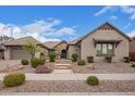 Beautiful single-story home featuring a stone facade, tile roof, and professionally landscaped front yard at 19318 E Walnut Rd, Queen Creek, AZ 85142