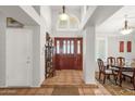 Grand foyer with high ceilings, decorative columns, tile flooring, and an elegant wooden front door at 1975 E Sunburst Ln, Tempe, AZ 85284