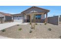 Charming single-story home with neutral tones, a two car garage and rock landscaping at 24192 W Agora Ln, Buckeye, AZ 85326