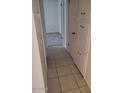 Hallway with tiled floors and ample closet space, leading to carpeted bedroom at 2549 W Rose Ln # A223, Phoenix, AZ 85017