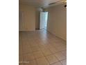 Spacious living room with tiled floors and open doorway to the outside at 2549 W Rose Ln # A223, Phoenix, AZ 85017