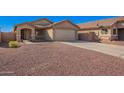 Inviting single-story home with desert landscaping, a two-car garage, and a charming entrance at 25797 W St Charles Ct, Buckeye, AZ 85326