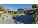 Charming home featuring manicured landscaping, gravel, and a modern walkway leading to the entrance at 2719 N Greenfield Rd, Phoenix, AZ 85006