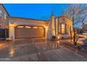 Charming single-story home with a three-car garage, well-lit exterior, and meticulously maintained landscaping at 31061 N 136Th Ln, Peoria, AZ 85383